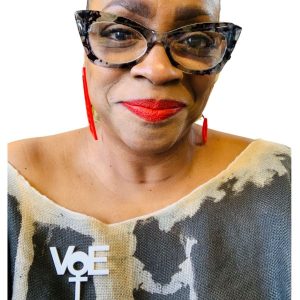 Takara Gudell of Takara Designs in Chicago, wearing one of her handmade Vote pins.